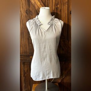 Silver sleeveless blouse NWOT.